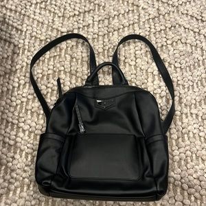 Backpack purse with lots of zippers and pockets.